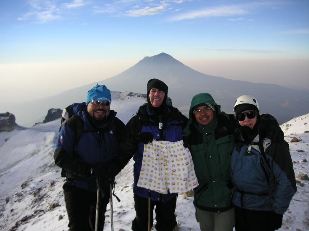 El Oso, John, Alfredo, and Steven at the summit of Izta with Popo in the background.